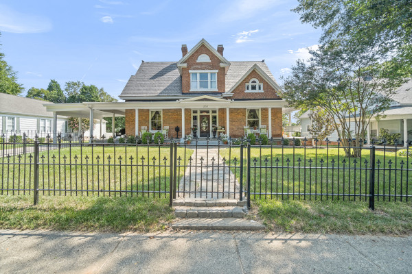 Brick home with iron fence